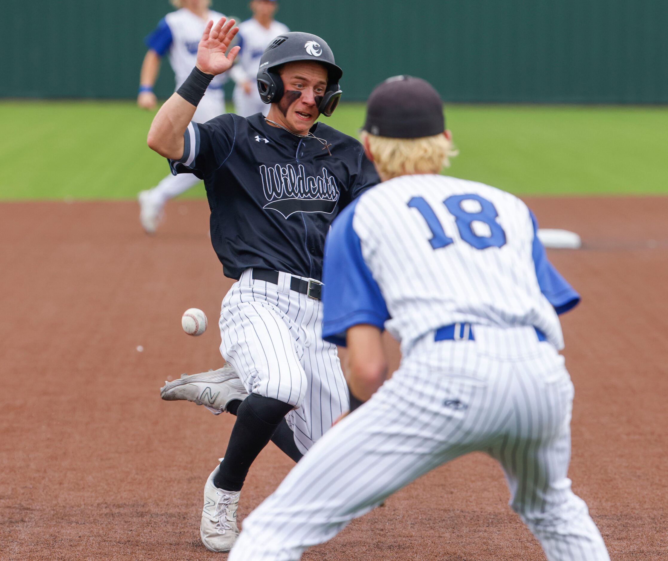 Denton Guyer’s Blade Carver safely reaches the third base past Byron Nelson’s Kurt Ippolito...