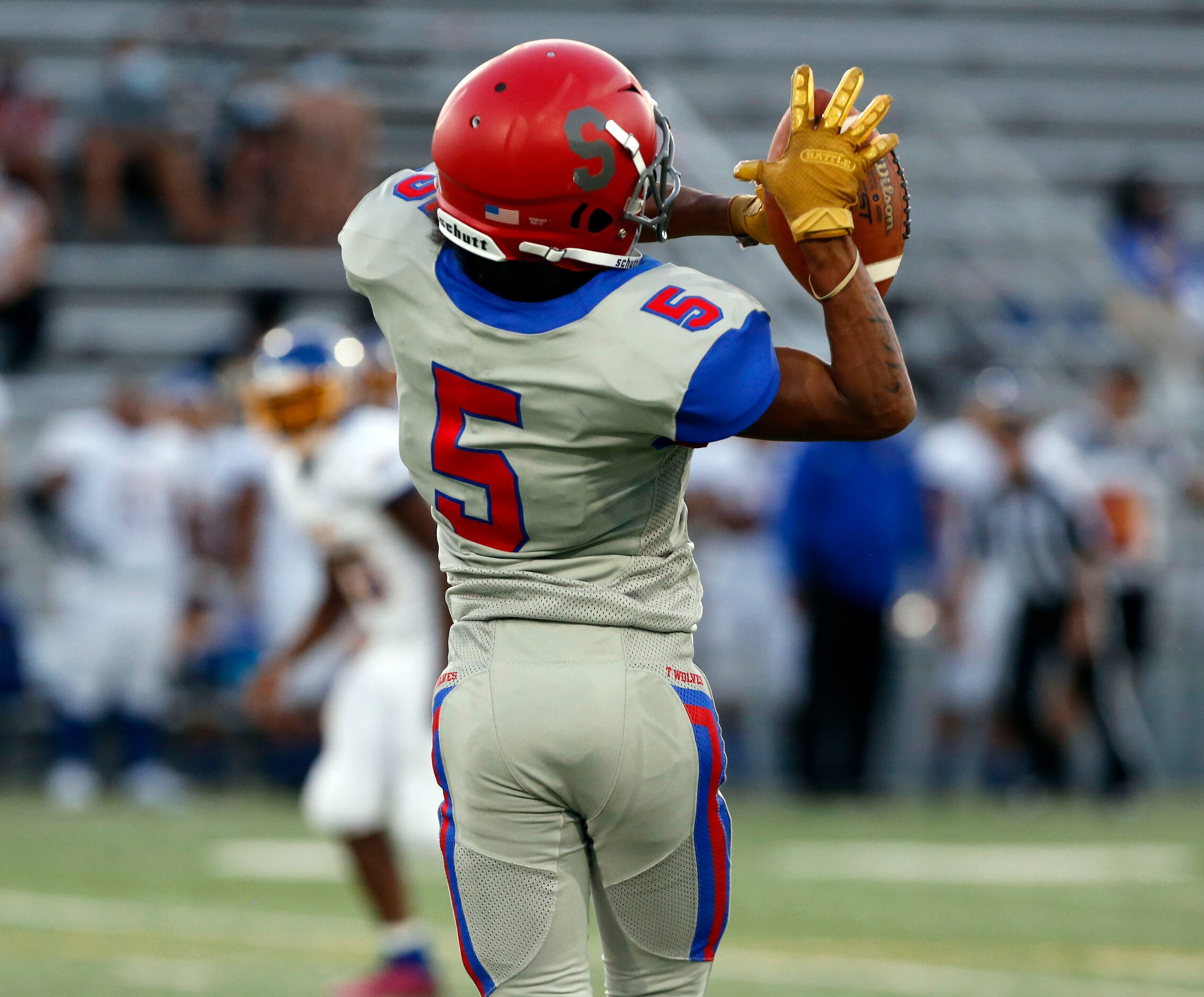 Spruce High Wilbert Trigg (5) grabs a pass during the first half of the season opening high...