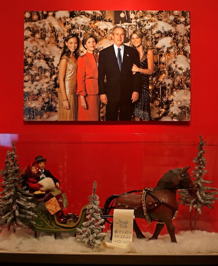 A family portrait of former President George Bush and first lady Laura Bush hangs on the...