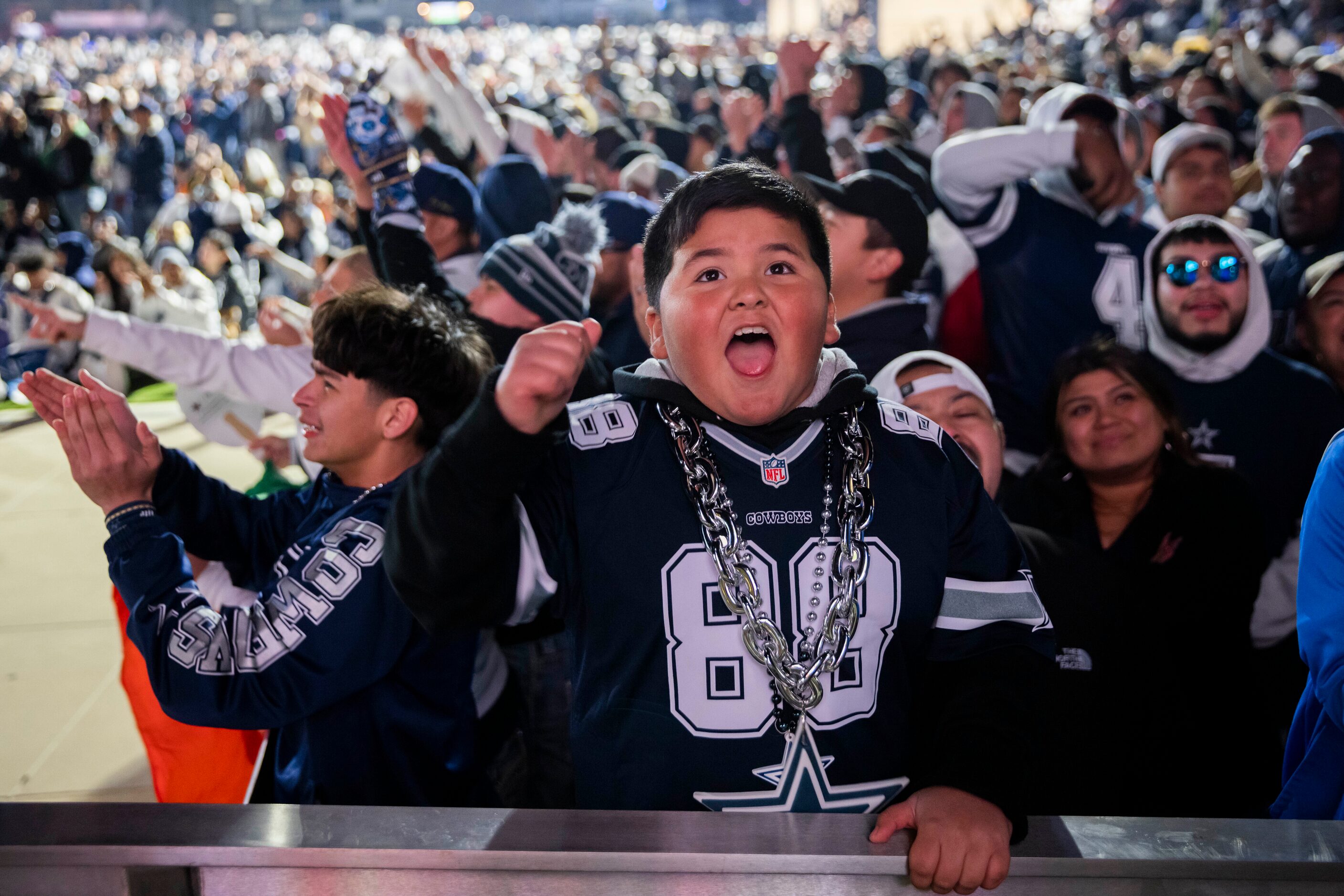 Isaiah Chávez, 10, reacts to a play by the Dallas Cowboys against the San Francisco 49ers in...