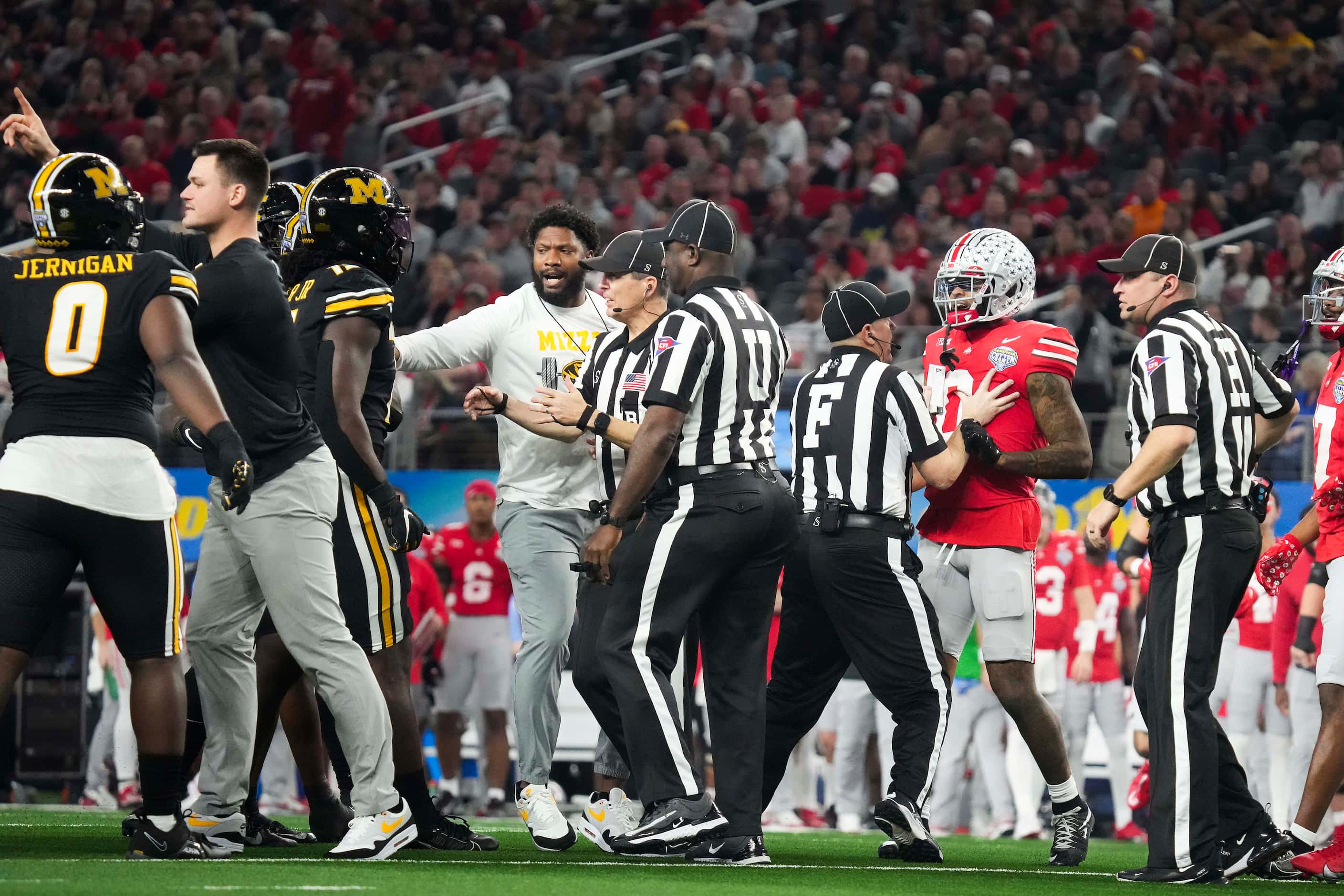 Officials and coaches trie to separate Missouri and Ohio State players during the first half...