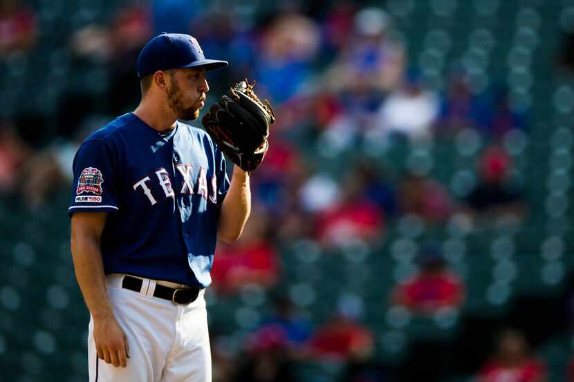 FILE - Rangers relief pitcher Adrian Sampson (52) is pictured during the ninth inning of a...