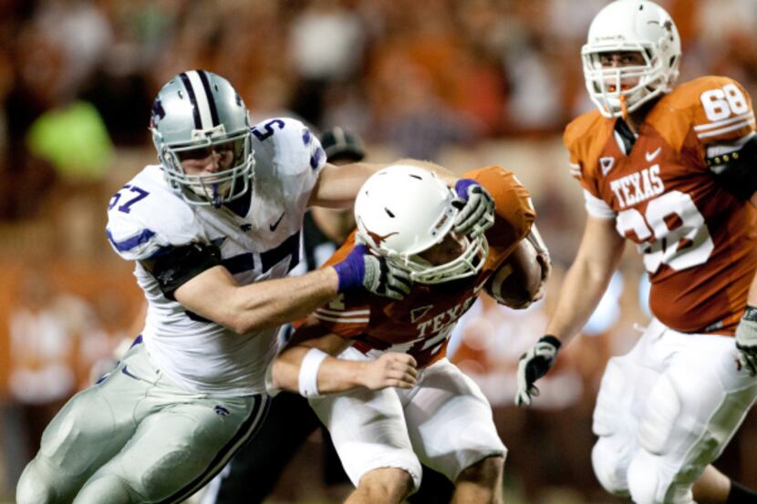 Jordan Voelker #57 of Kansas State tackles David Ash #14 of Texas in the first half of a...