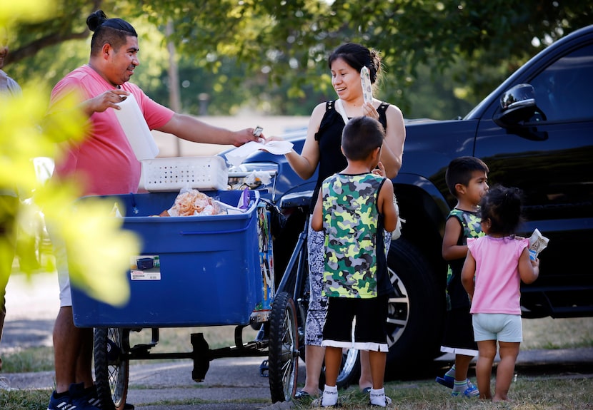 Paletero Manuel Maldonado (left), a 32-year-old paleta vendor from Paleteria Delicias in Oak...