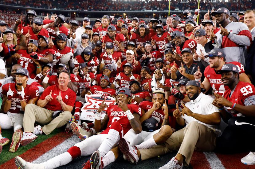 The Oklahoma Sooners football team poses for a Big XII Championship winning photo after...