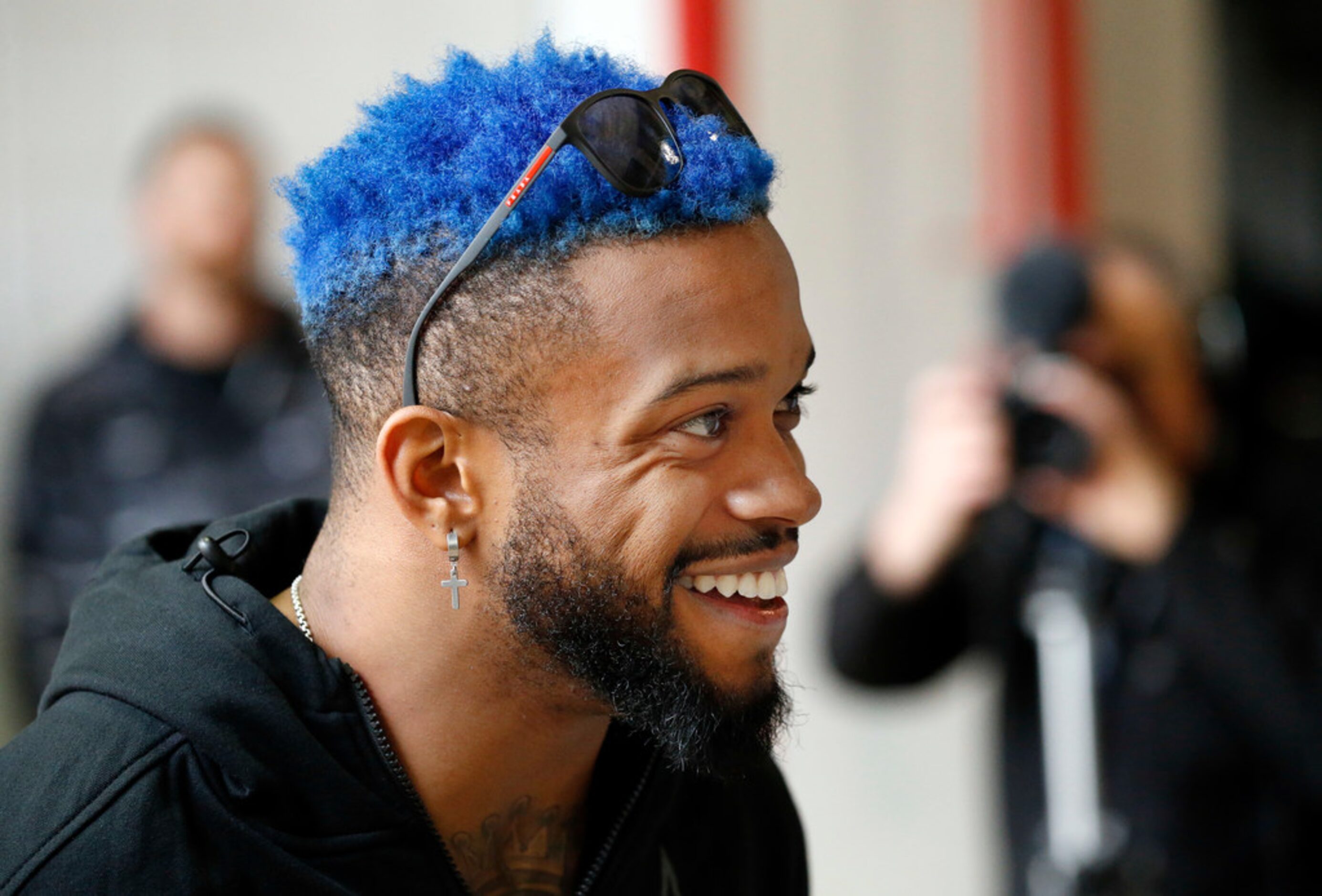 Texas Rangers outfielder Delino DeShields sports blue hair before dropping a Spring Training...