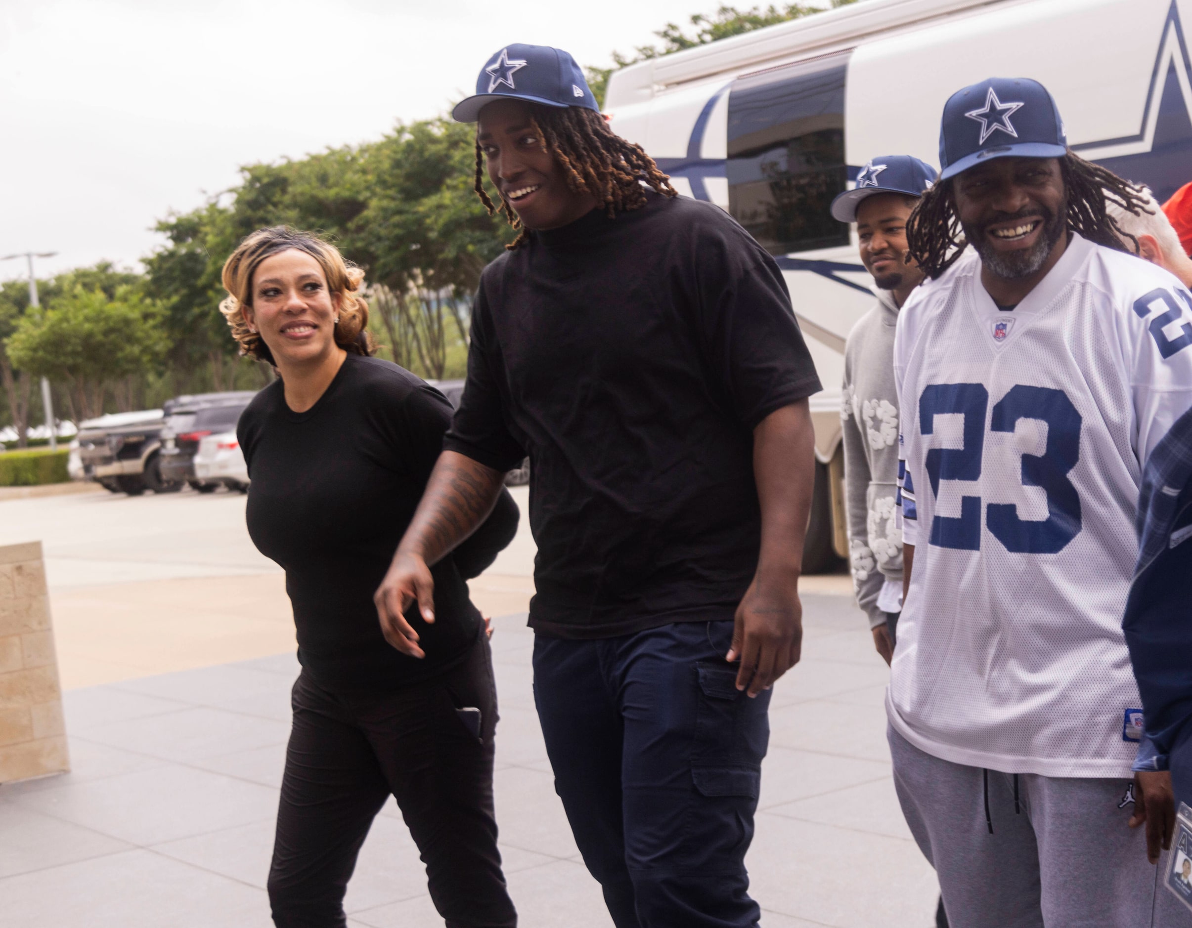 The new Dallas Cowboys left tackle Tyler Guyton, center left, walks with mom Makenzie...