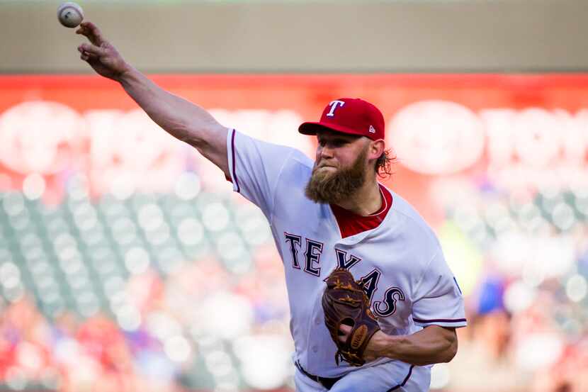Texas Rangers starting pitcher Andrew Cashner delivers a pitch during the first inning...