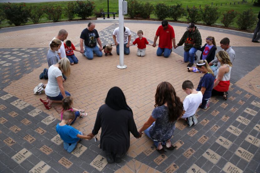 People gathered at at Ben Gill Park's flag pole in Terrell to pray for the family and...