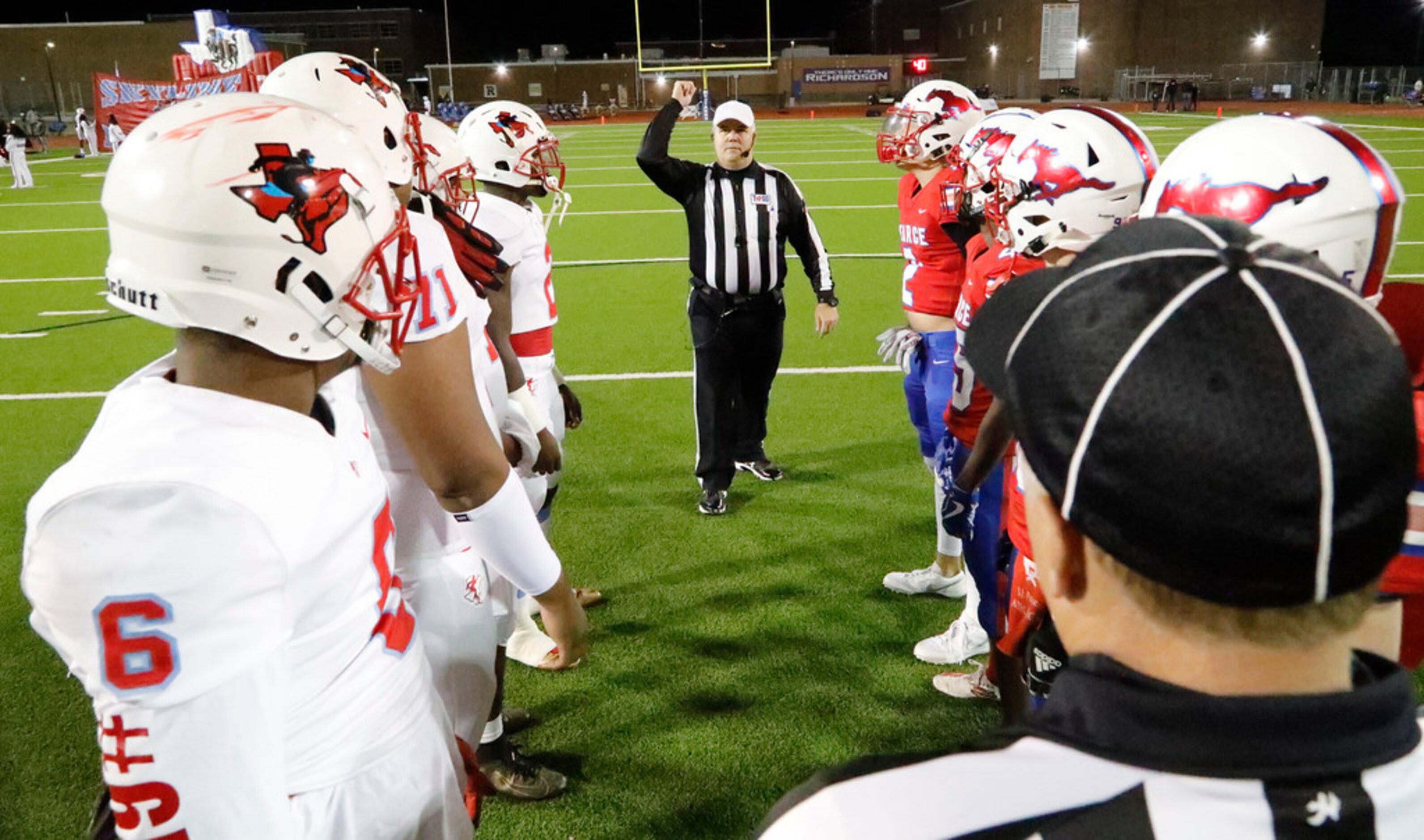 Team captains gather at midfield for the coin toss as J.J. Pearce High School hosted Skyline...