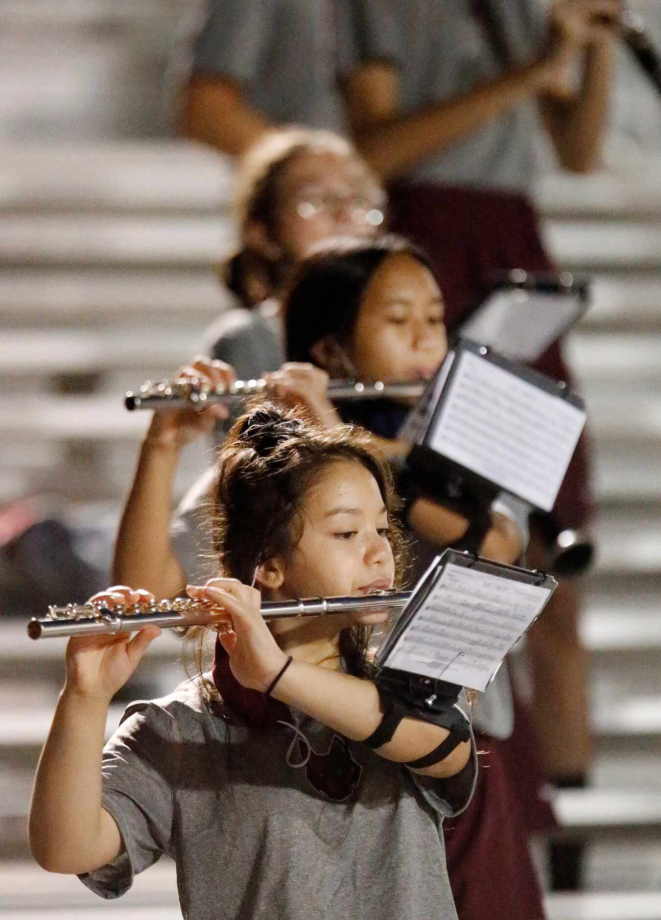 The Heritage High School marching band perfoms during the first half as Heritage High School...