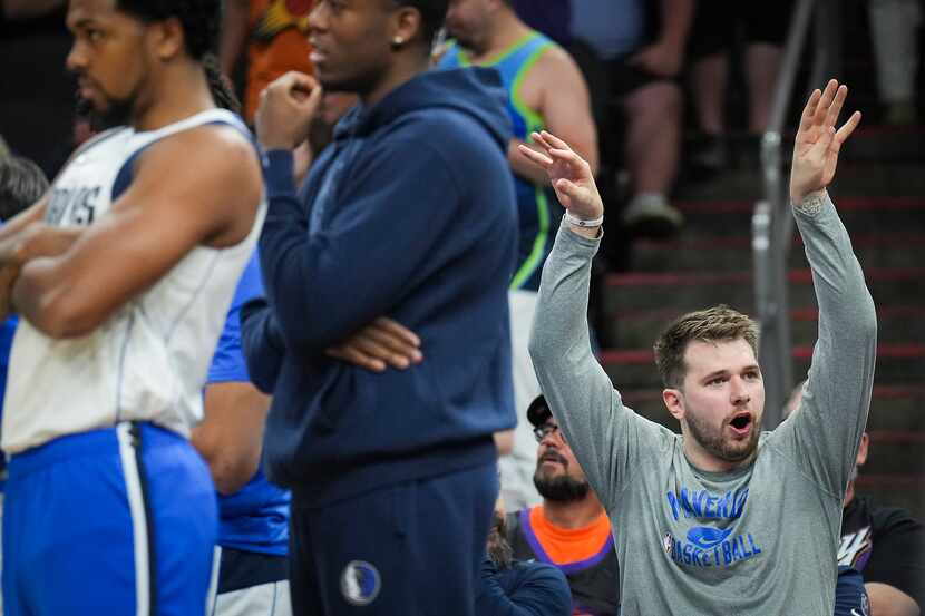 Dallas Mavericks guard Luka Doncic celebrates on the bench during the third quarter in Game...