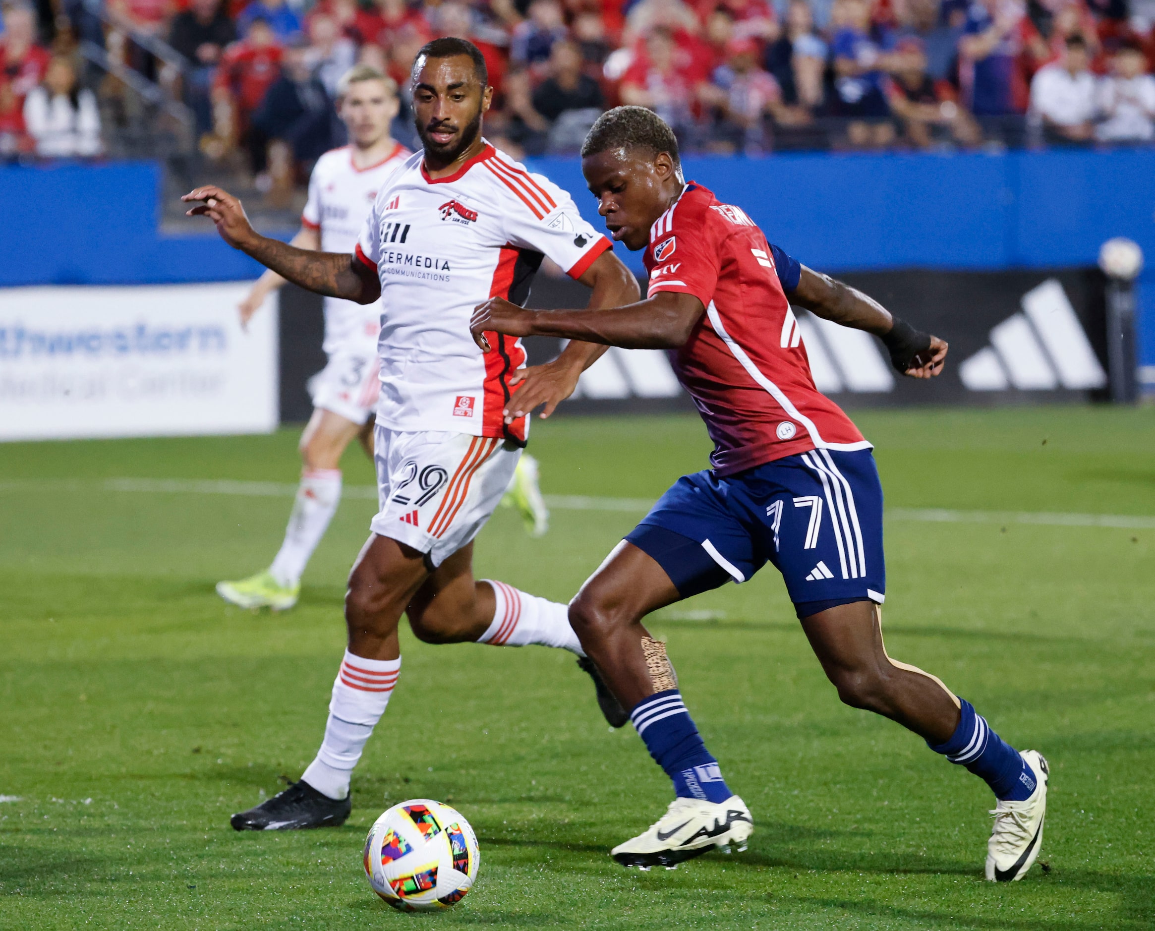 San Jose defender Carlos Akapo (back) follows as FC Dallas forward Bernard Kamungo attempt...