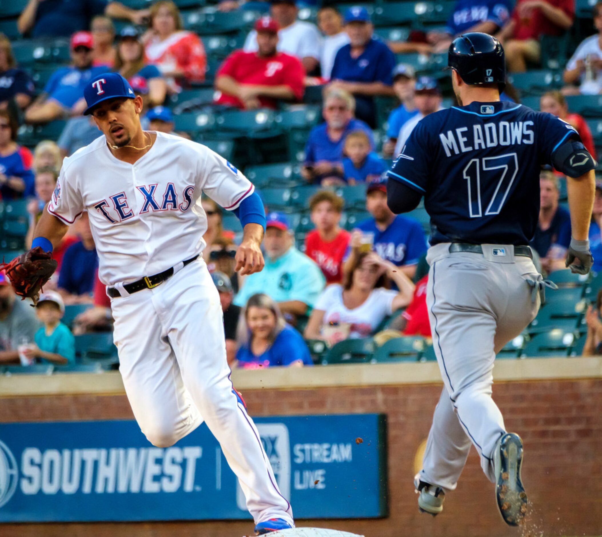 Texas Rangers first baseman Ronald Guzman (11) beats Tampa Bay Rays outfielder Austin...