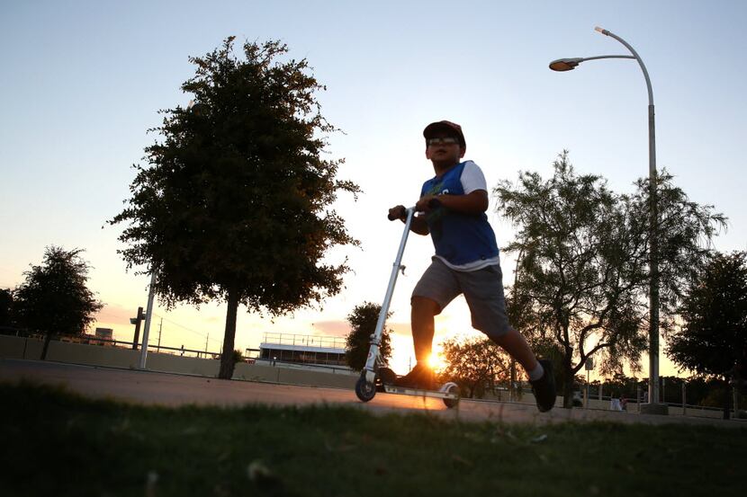 Nathaniel Ortiz, 7, rides a scooter near the Ronald Kirk Pedestrian Bridge in Dallas on...