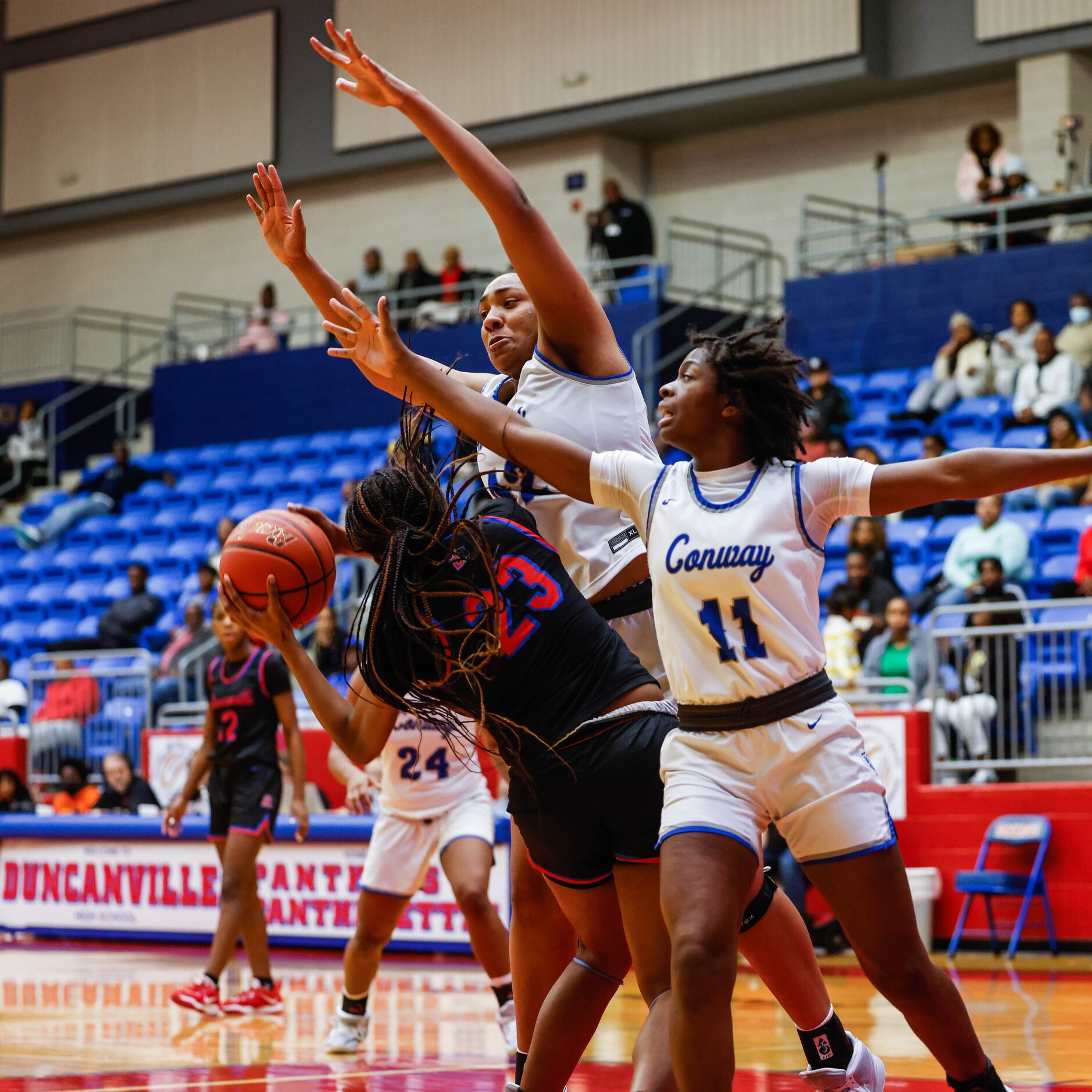 Duncanville Pantherettes' Mariah Clayton (23) tries to make a pass against Conway Lady Cats'...