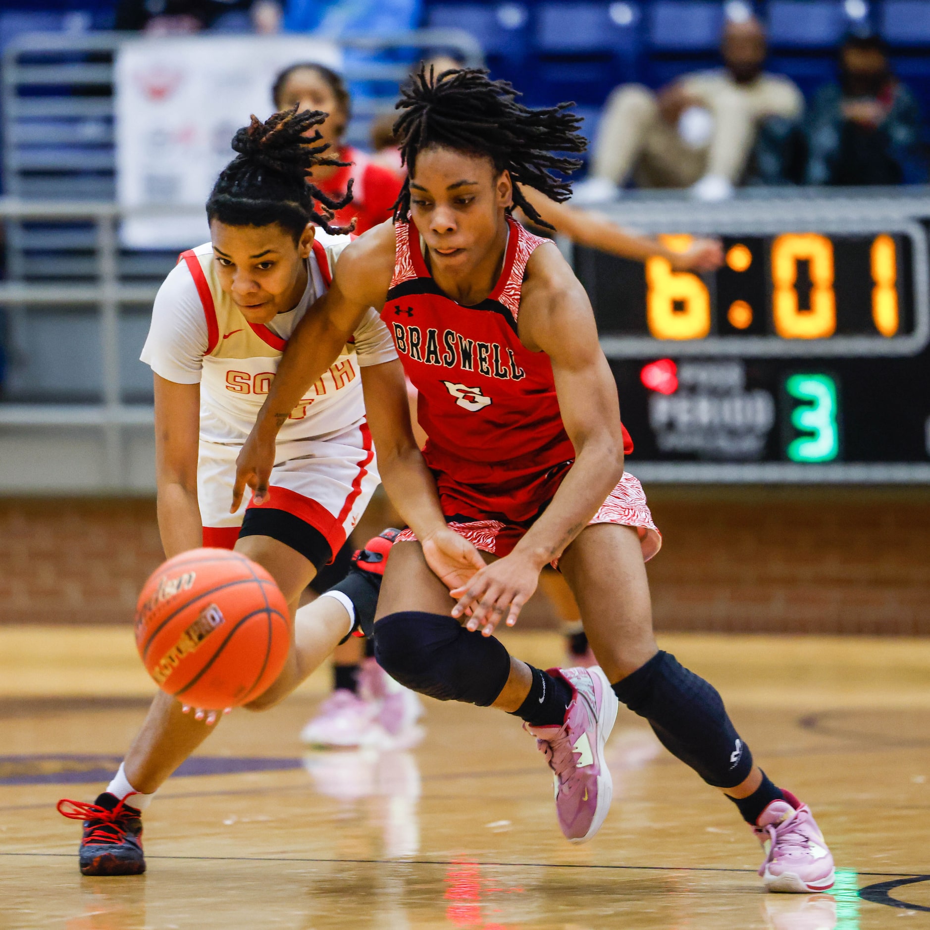 South Grand Prairie's Joy Madison-Key (4) and Denton Braswell's Danae Crosby (5) go for the...