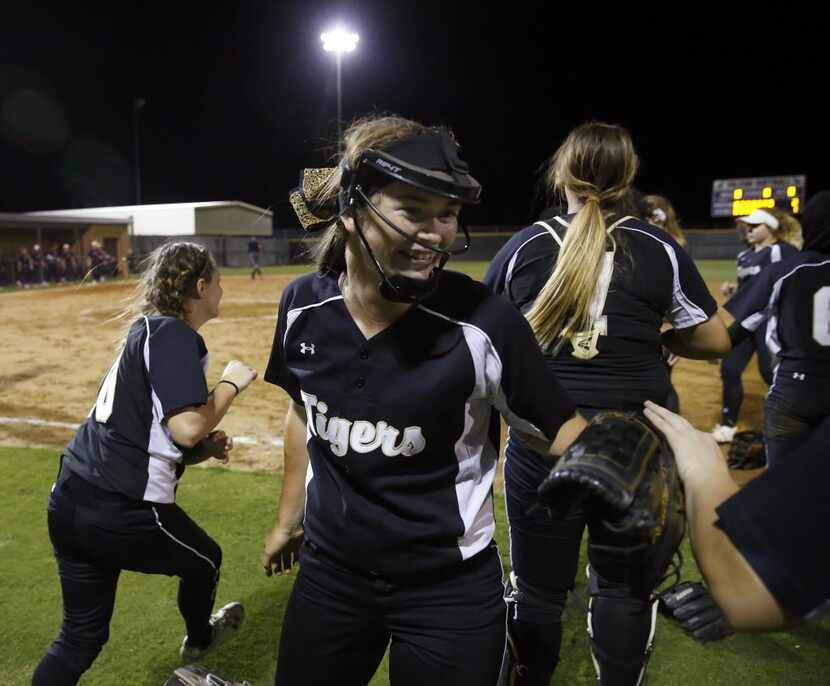Mansfield's starting pitcher Paxton Scheurer is all smiles as she is congratulated after her...