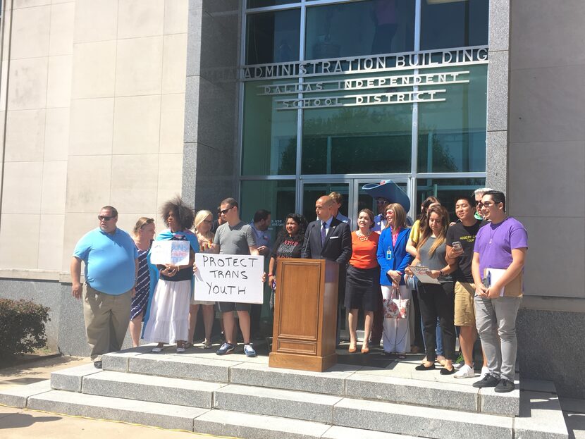 DISD trustee Miguel Solis in front of headquarters with members of the community surrounding...