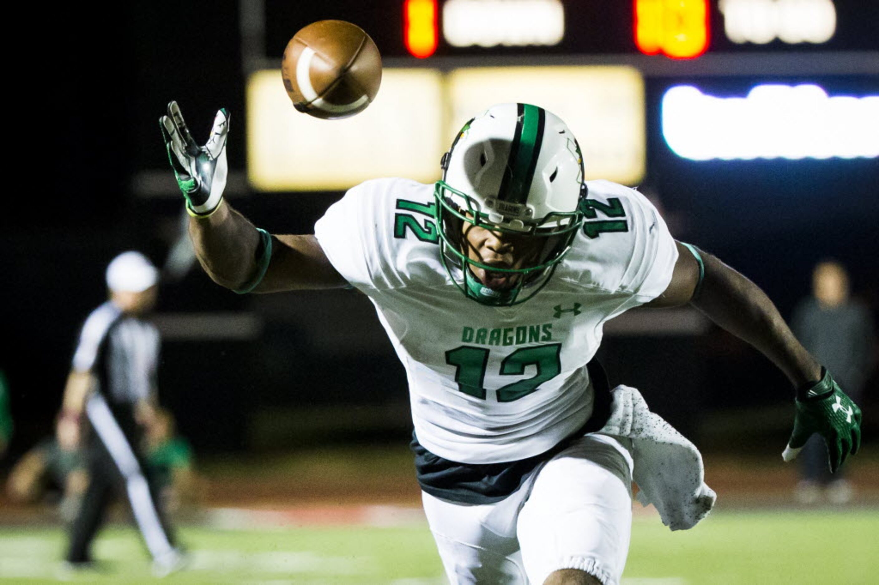 Southlake Carroll wide receiver Zach Farrar (12) has a pass go off his hands during the...