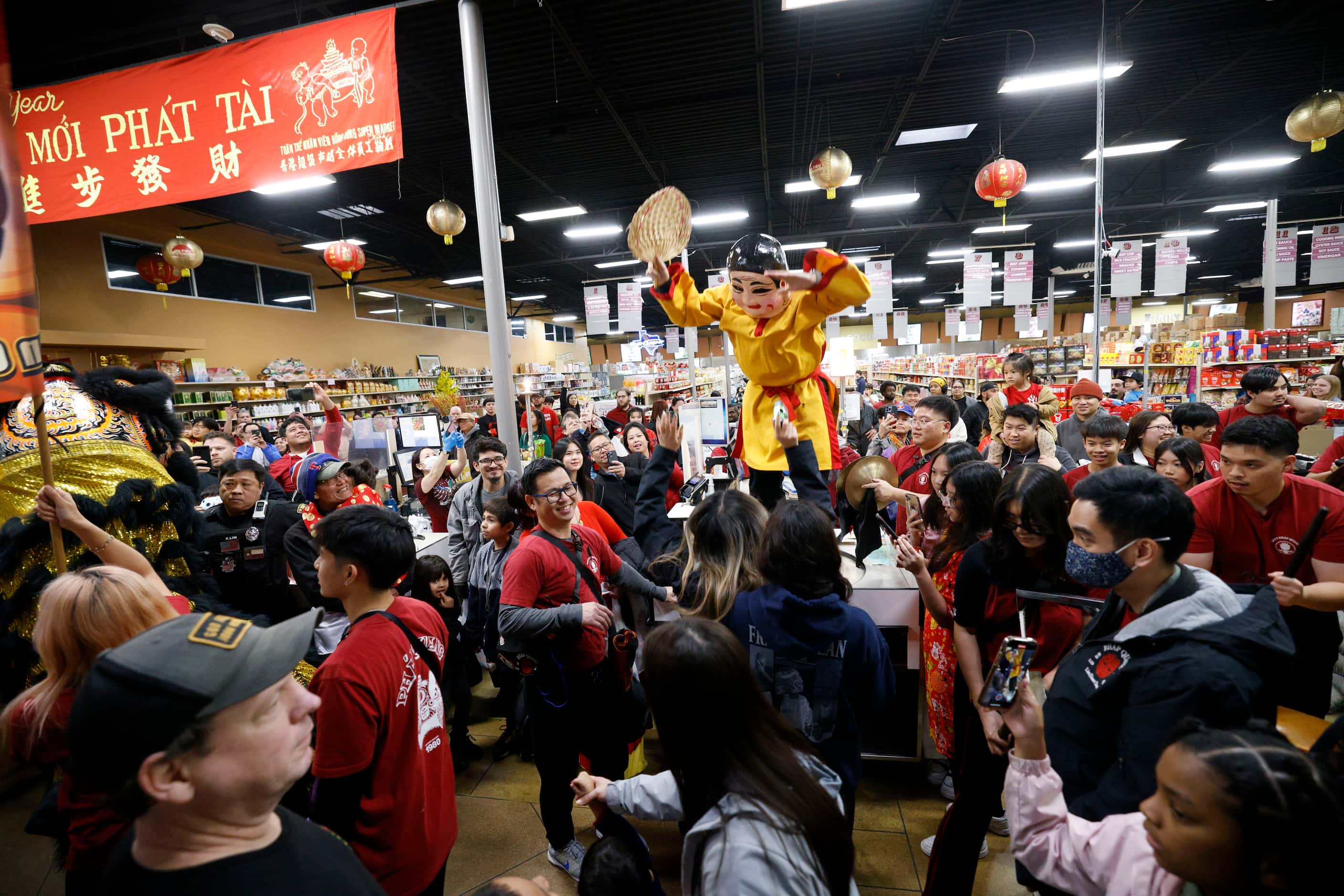 Lion dancers from GDPT Phap Quang perform inside a supermarket during a Luna New Year...