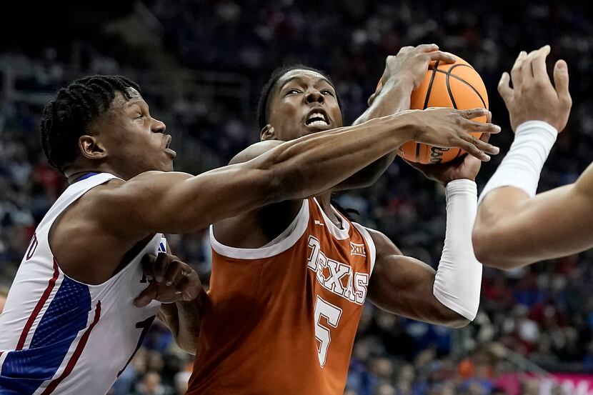 Texas guard Marcus Carr (5) shoots under pressure from Kansas guard Joseph Yesufu (1) during...