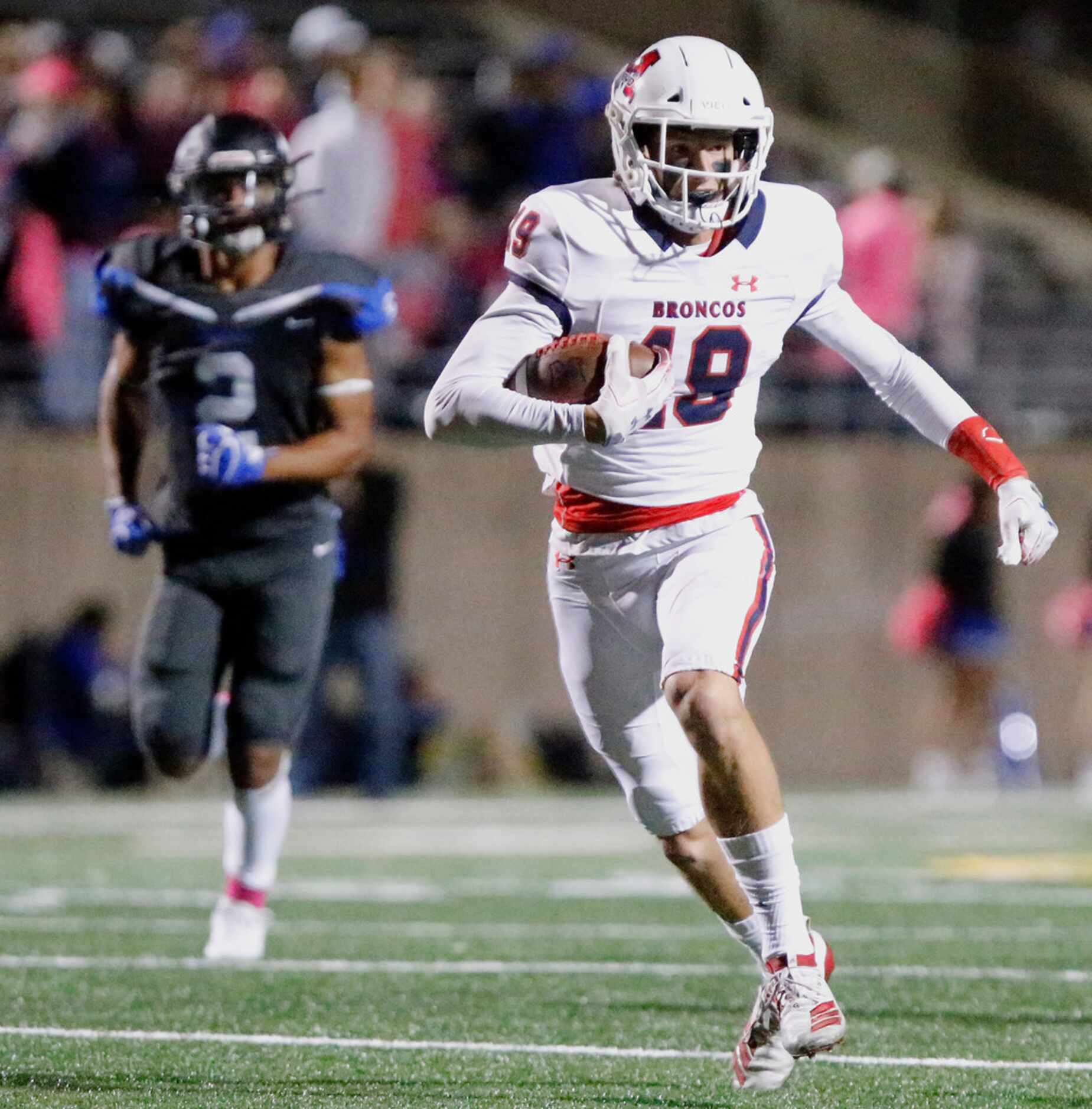 McKinney Boyd High School wide receiver Jack Hagan (19) runs after the catch in front of...