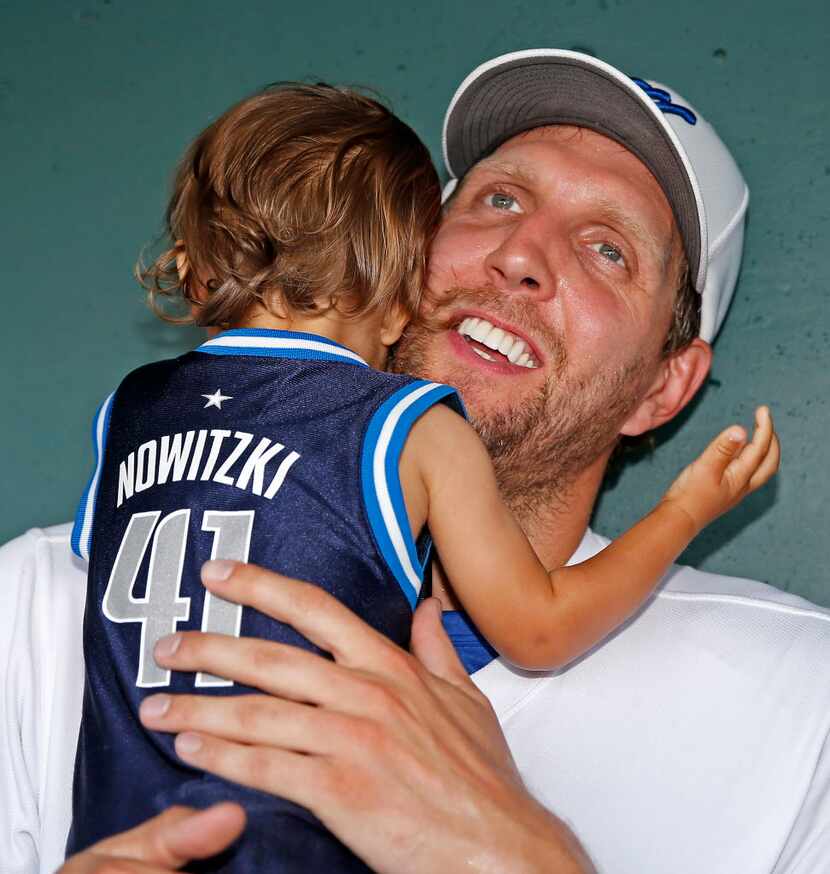 Dallas Mavericks Dirk Nowitzki poses for a photo with his 1-year-old son Max Nowitzki in the...