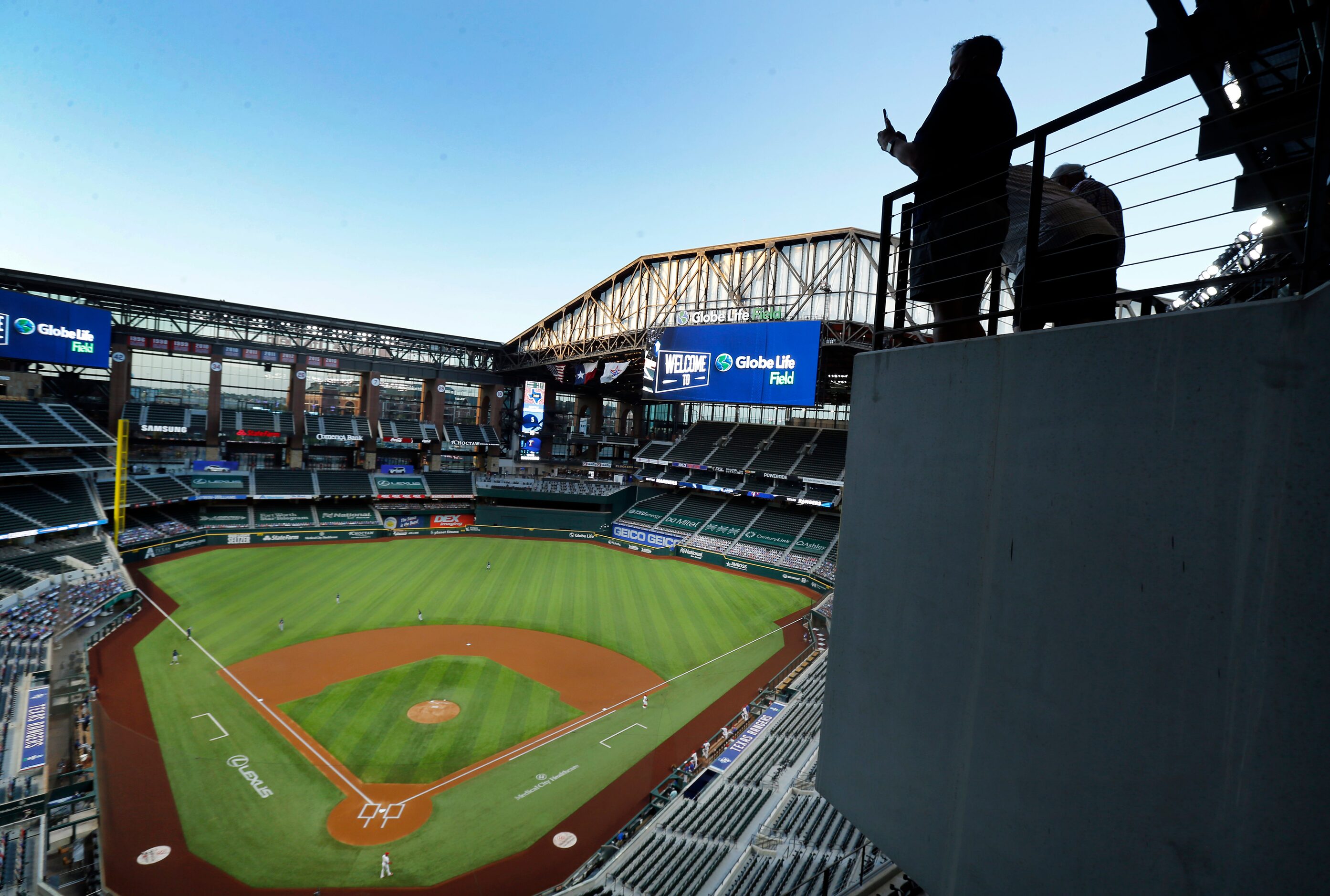 Sports reporters photograph Globe Life Field after the retractable roof was opened for the...