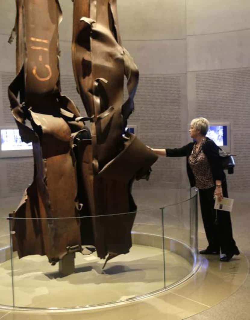 
Deborah Jurcak of Grapevine touches the World Trade Center tower beams in the 9/11 exhibit...