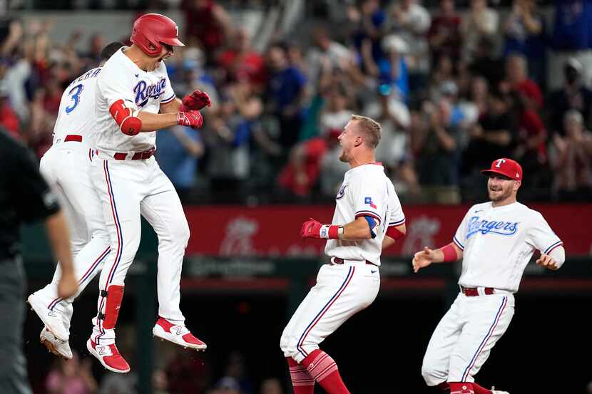 From left to right, Texas Rangers' Leody Taveras (3), Nathaniel Lowe, Josh Jung and Robbie...