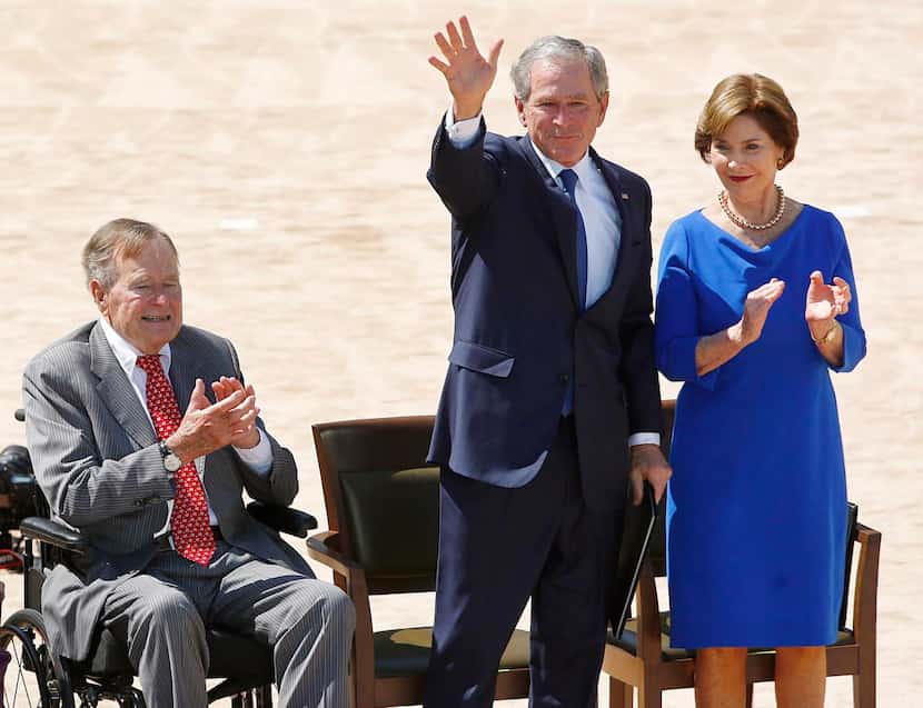 George H.W. Bush , with son George W. and his wife Laura at the dedication of the George W....