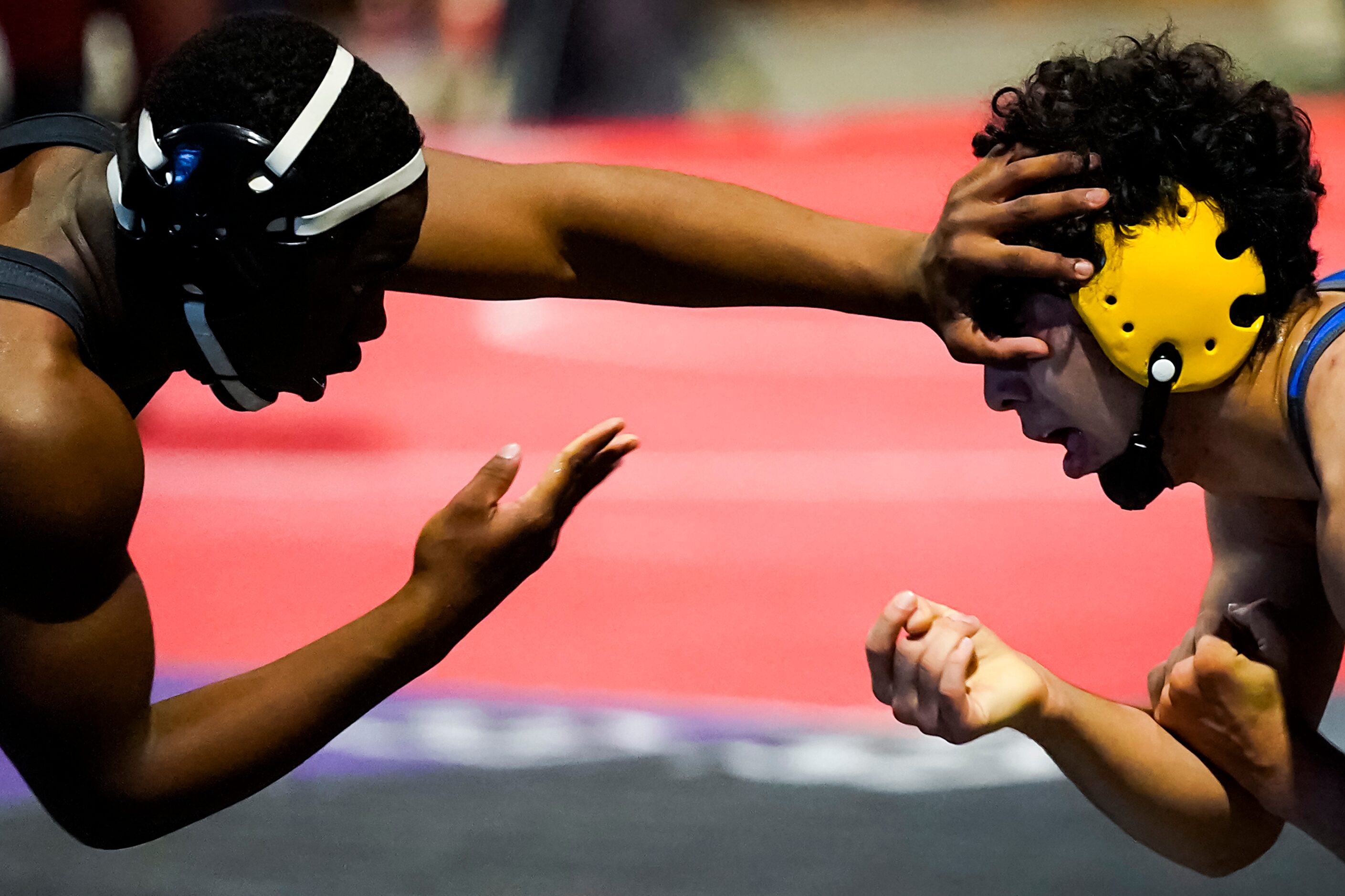 Donavan Whitted of Arlington Martin (left) wrestles Roberto Bautista of Klein for the 6A...