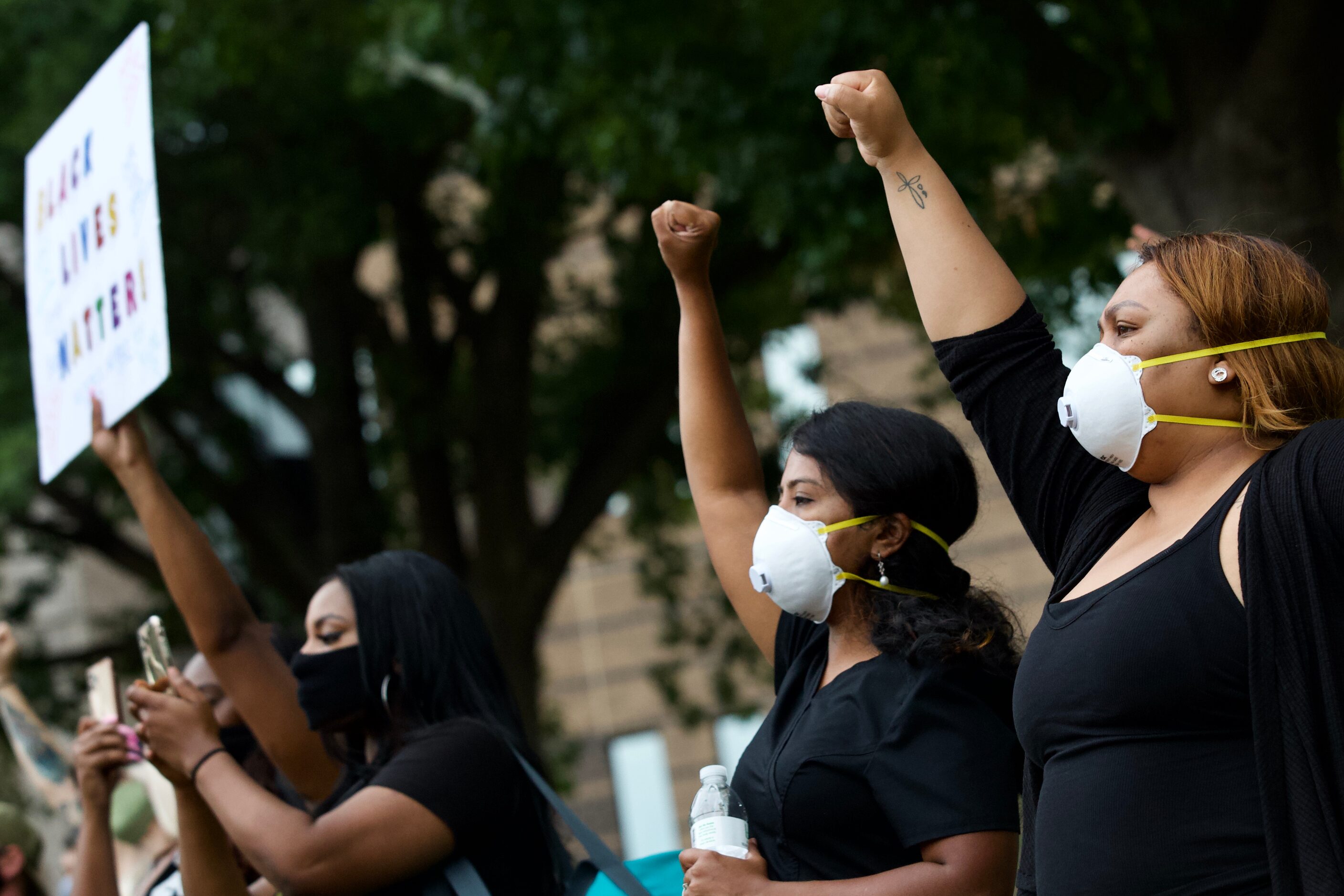 Lanie Alexander (far right) and Lalitha Natarajan (2nd from right) join protesters gather...