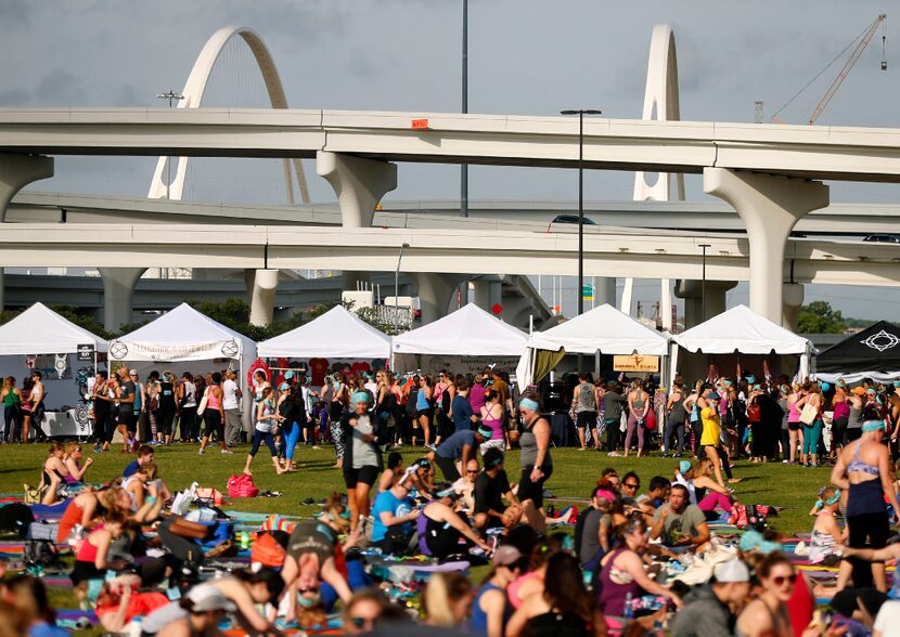 Yoga enthusiasts shop the vendors set up at Wanderlust. The whole event was within sight of...