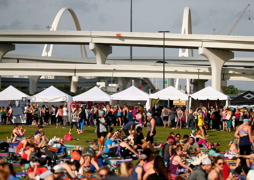 Yoga enthusiasts shop the vendors set up at Wanderlust. The whole event was within sight of...