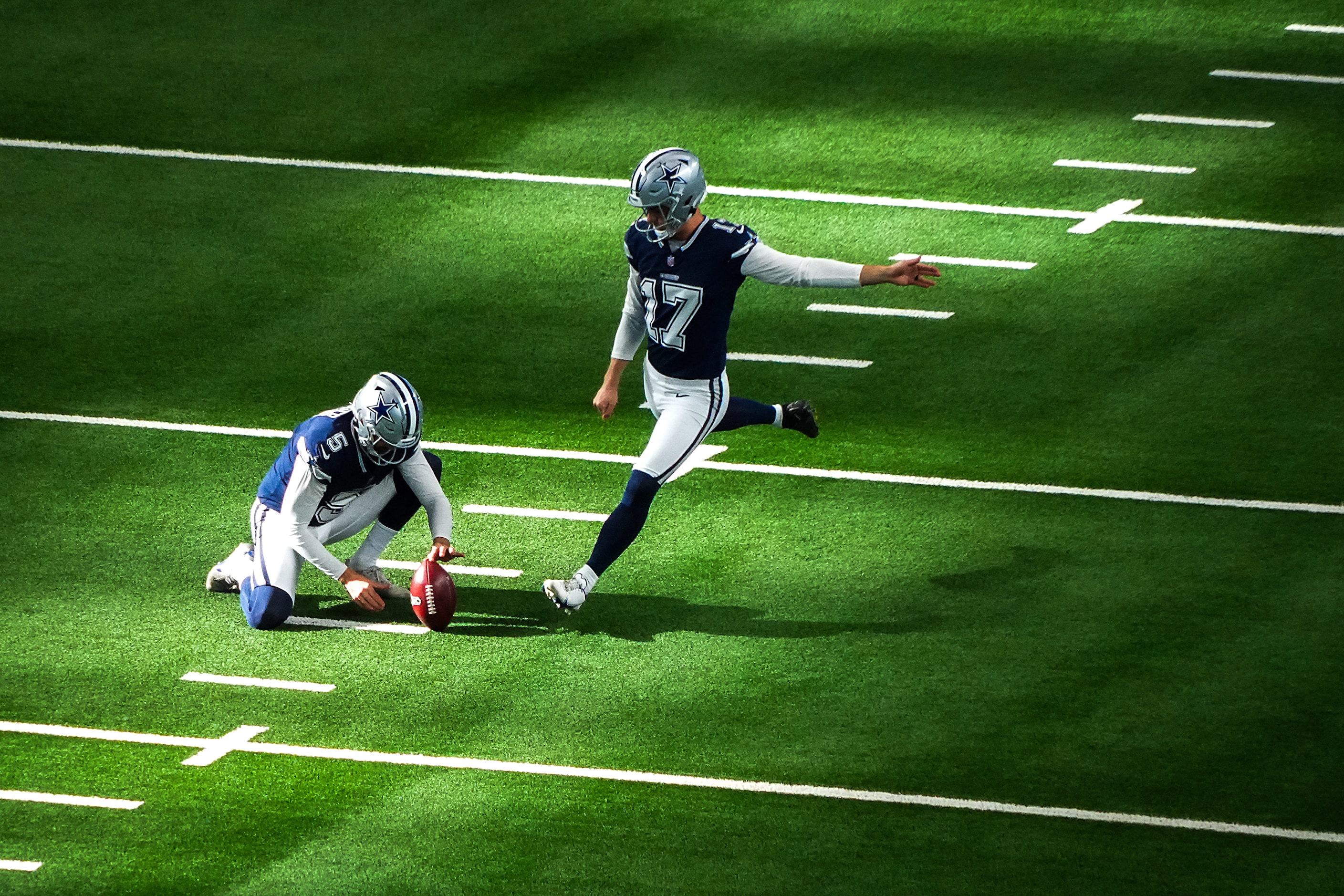 Dallas Cowboys place kicker Brandon Aubrey (17) warms up with punter Bryan Anger (5) before...