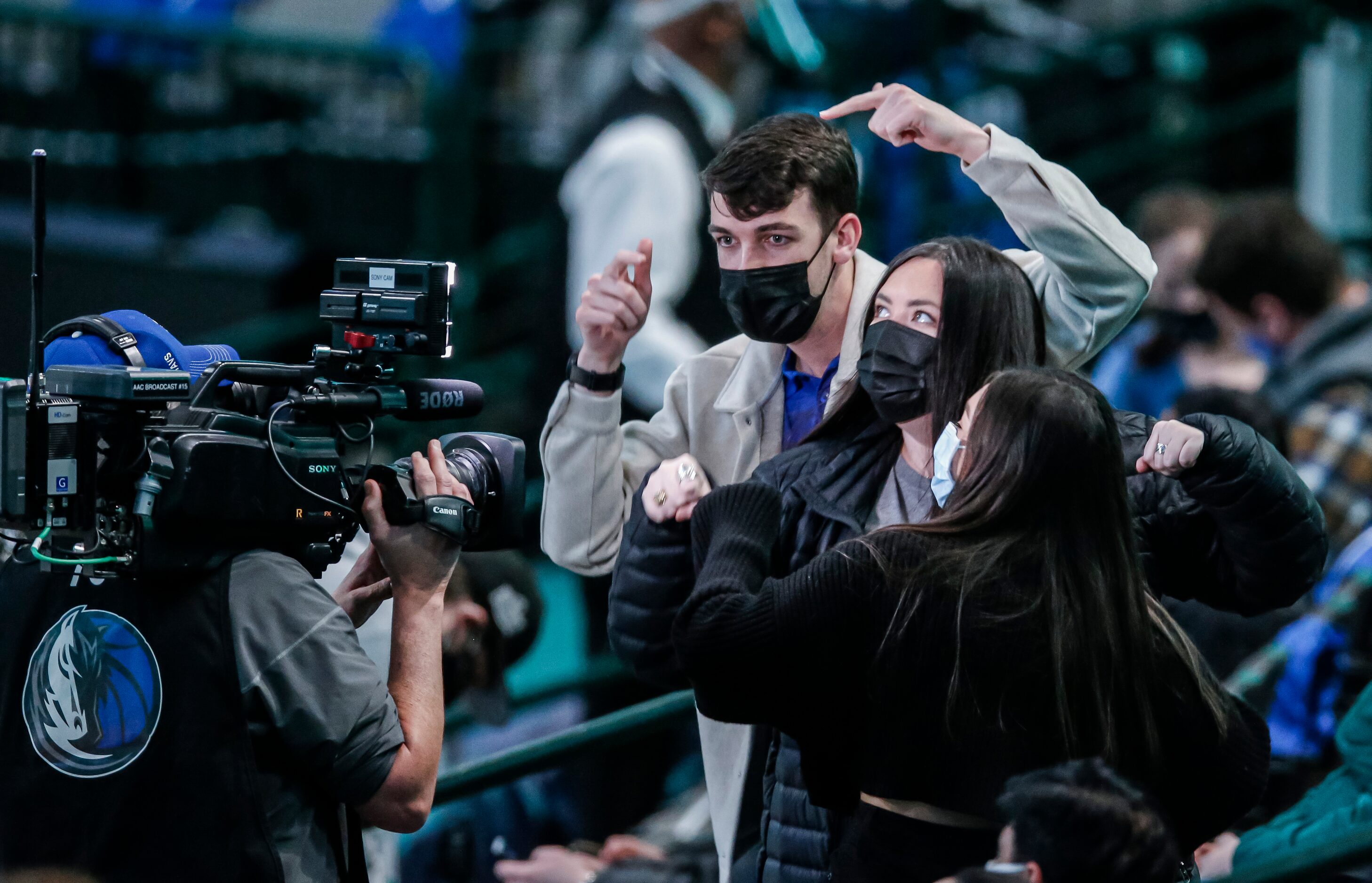 Fans, consisting mostly of healthcare workers, dance for the fancam during an NBA basketball...