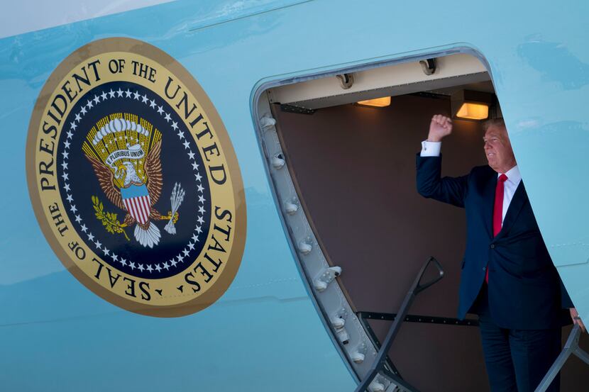 President Donald Trump greets supporters as he arrives on Air Force One in Dallas on Thursday.