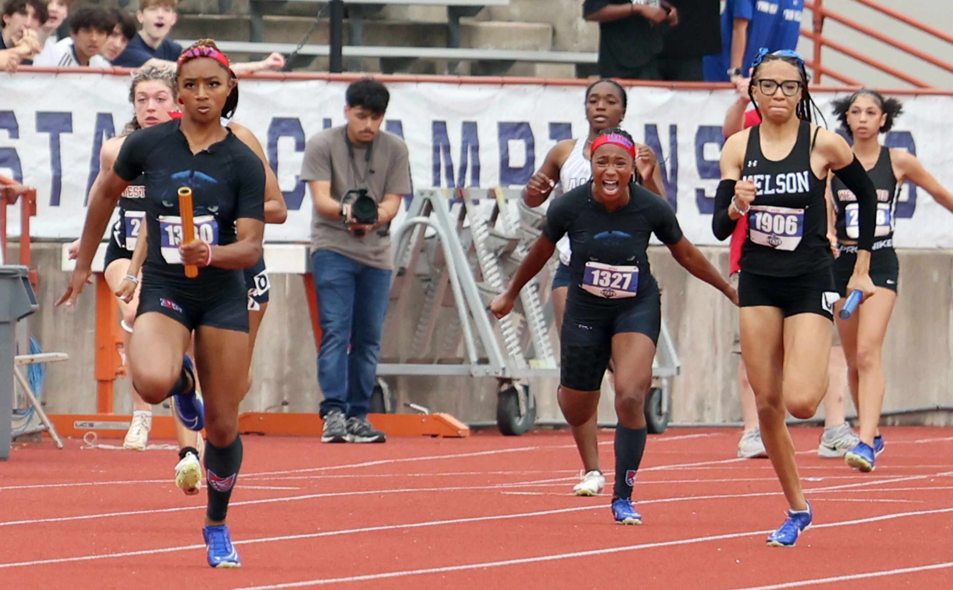 Duncanville anchor Sanyah Keeton, left, sprints to the finish line after receiving the baton...