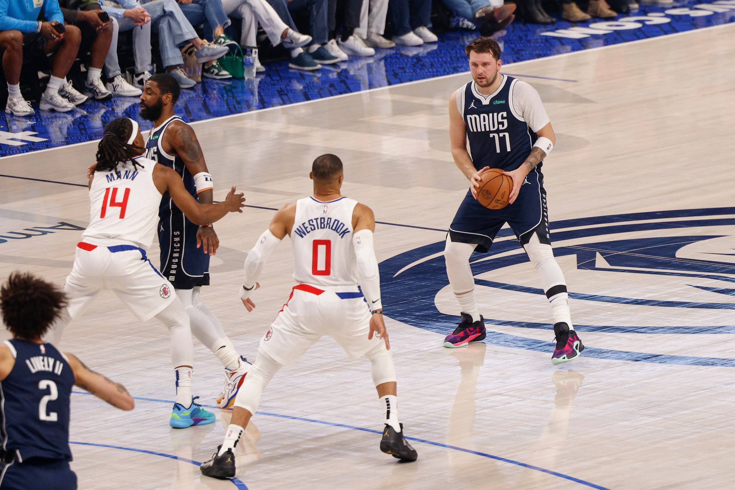 Dallas Mavericks guard Luka Doncic (77) looks to pass as he’s guarded by LA Clippers guard...