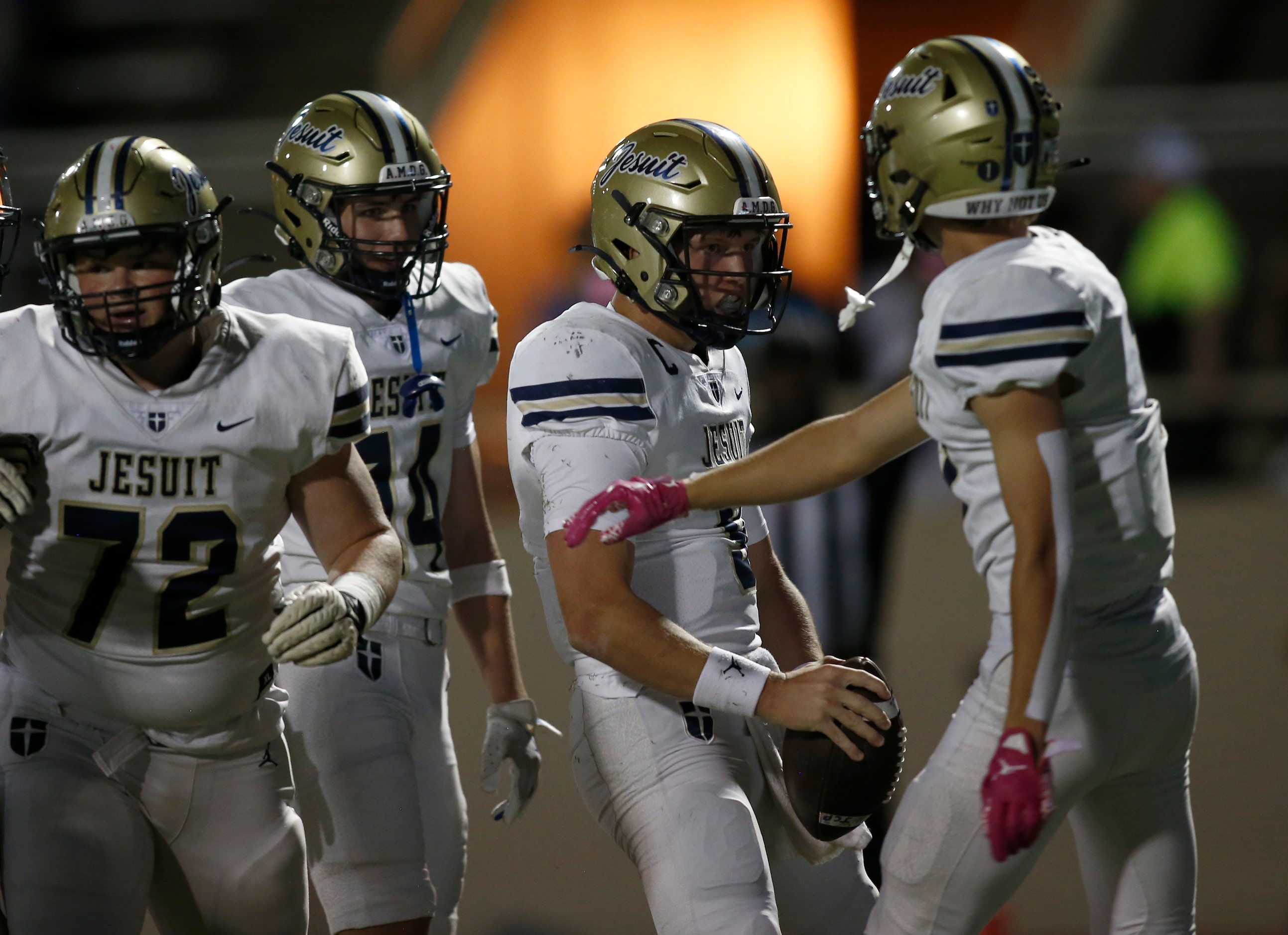 Jesuit quarterback Charlie Peters (9) celebrates with wide receiver Jack Yeskie (1), wide...