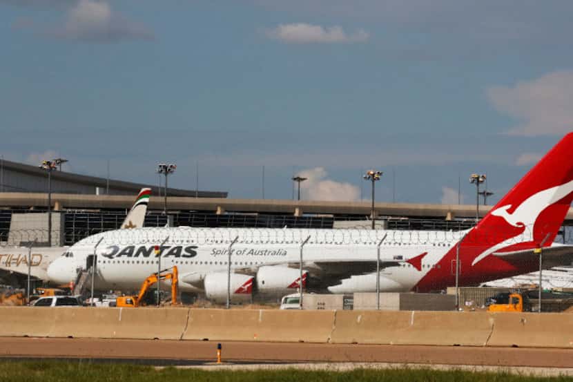 Qantas Airlines airplane parked on the tarmac at DFW International Airport