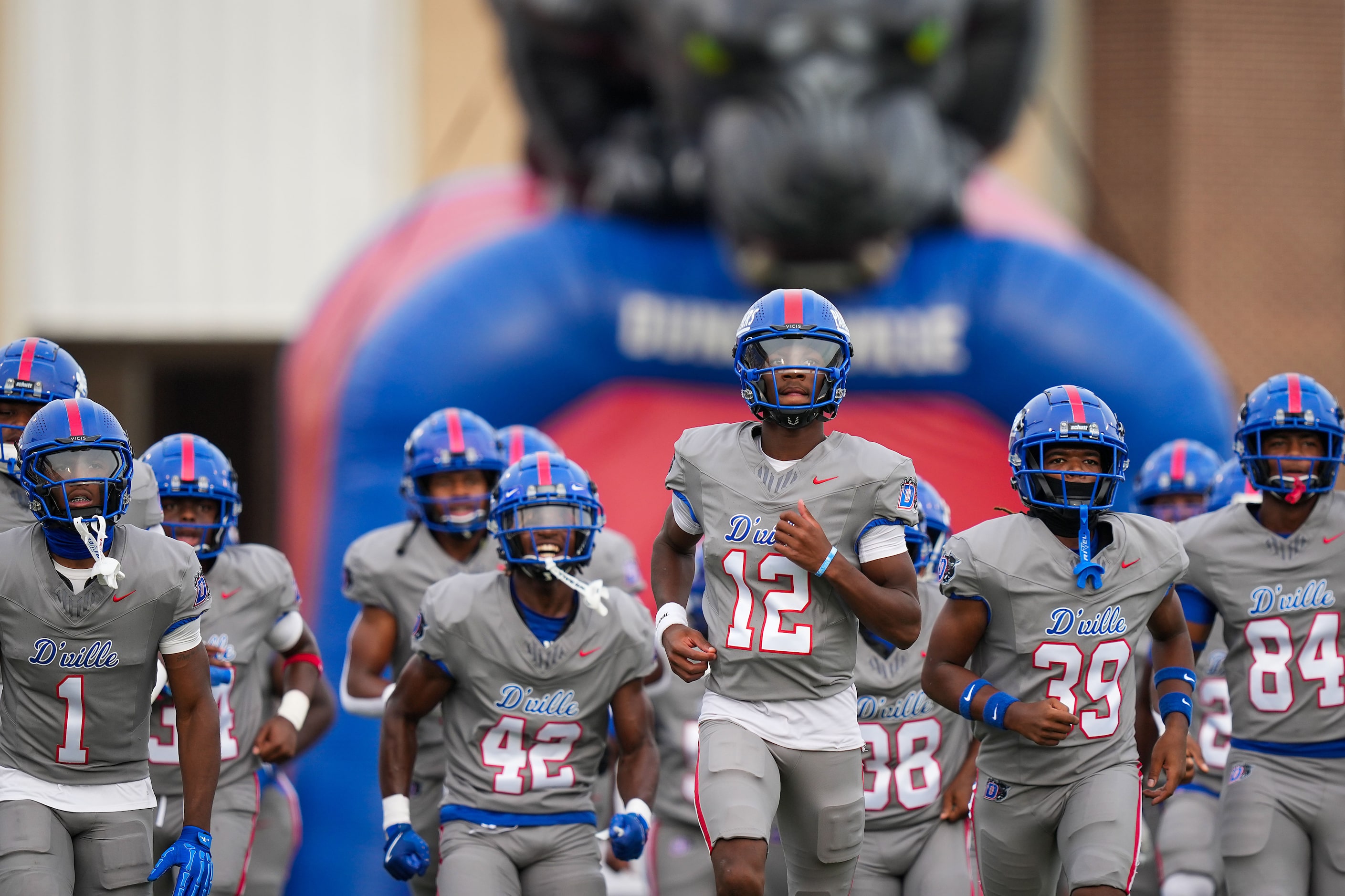 Duncanville quarterback Keelon Russell (12) leads his team as they take the field for a high...