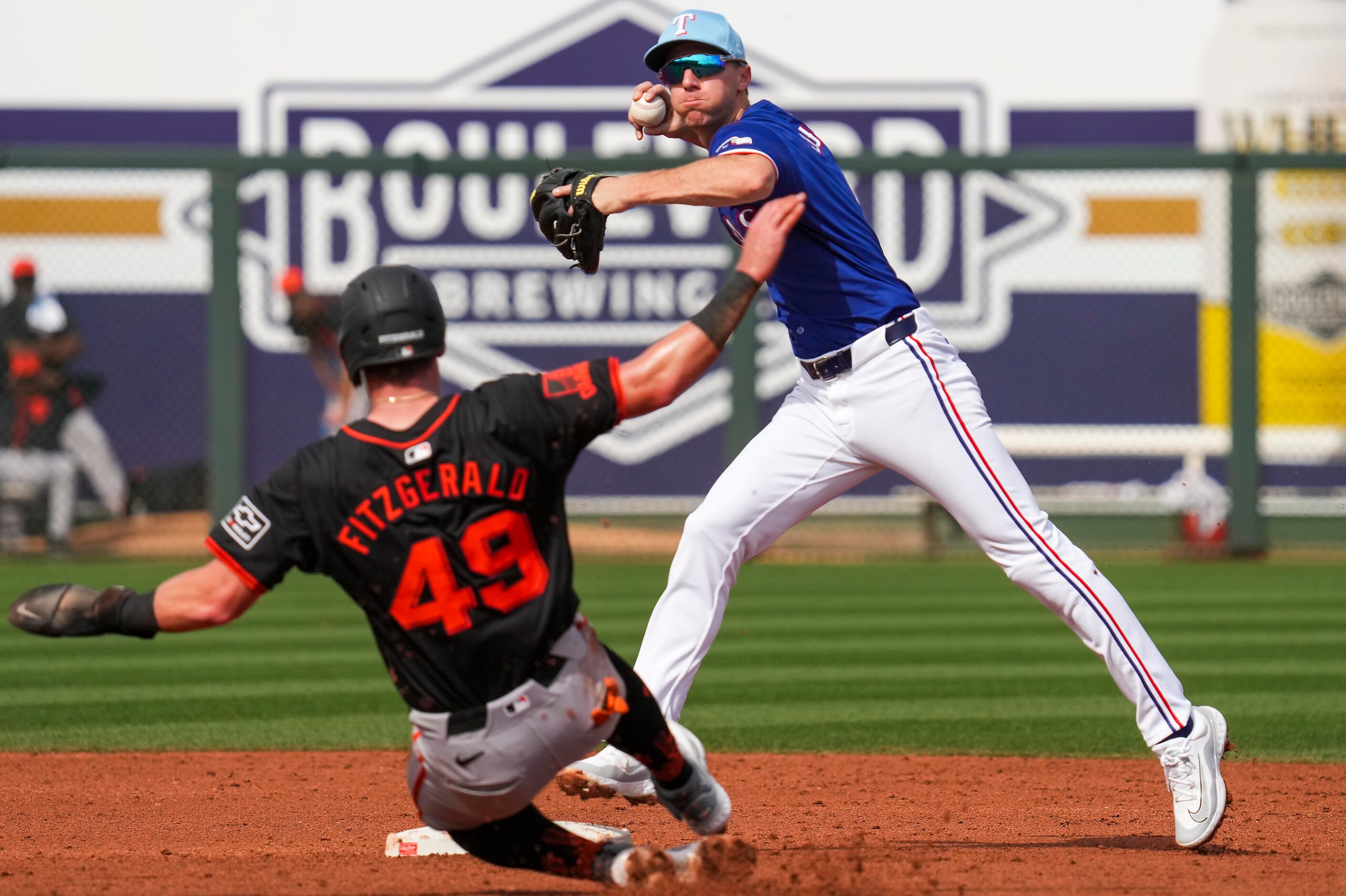 Texas Rangers shortstop Matt Duffy completes an inning-ending double play over San Francisco...