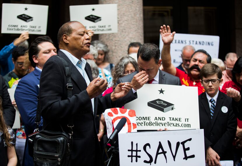 Dallas Pastor Stephen Broden leads a closing prayer during a press conference as part of...