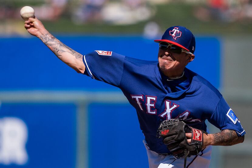 Texas Rangers pitcher Jesse Chavez pitches during the second inning of a spring training...
