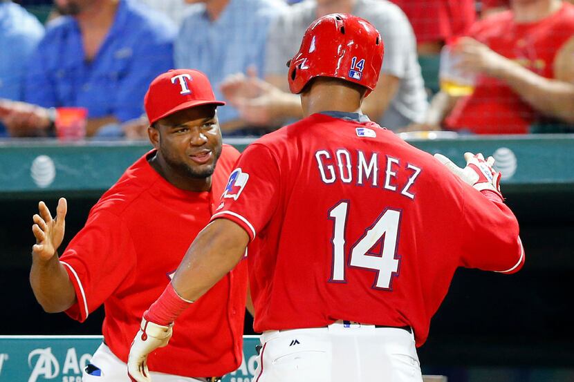 Texas Rangers left fielder Carlos Gomez (14) is congratulated by Hanser Alberto after...