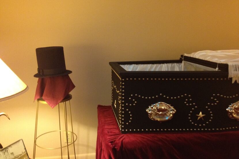 A stovepipe hat and a portrait of Abraham Lincoln are on display with a replica of the 16th...