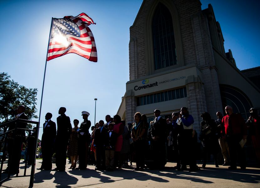 The Spann family and friends stand outside Covenant Church during funeral services for...